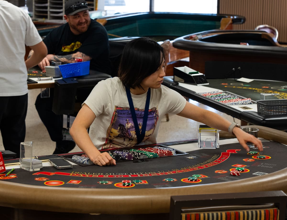 Professional dealer working a blackjack table at the Las Vegas training facility